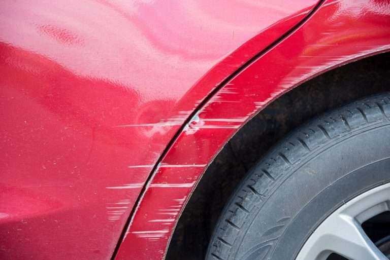 A scratched red car